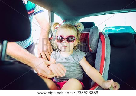 Father Fasten Blondy Baby Daughter 2-3 Year Old In Car Seat Standing On Parking. Transport, Safety, 