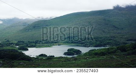 Lake And Green Hills. A Scenic View Of A Kerry Mountains And Surrounding Areas In County Kerry. Aged