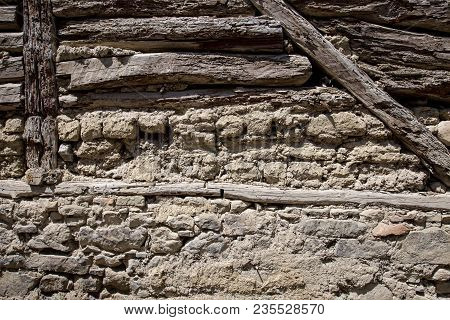Stone Wall With Stone, Wood And Mud Background
Rustic Wall In A Old Construction With Stone, Wood An
