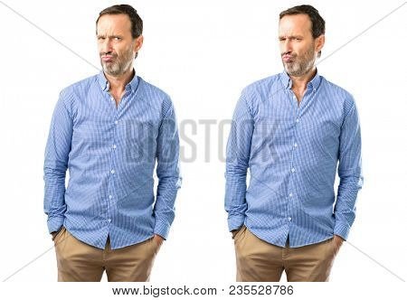 Middle age handsome man making funny face fooling over white background