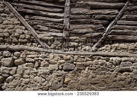 Stone Wall With Stone, Wood And Mud Background
Rustic Wall In A Old Construction With Stone, Wood An
