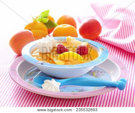 Creamy Pureed Fresh Apricot Soup With Raspberry.