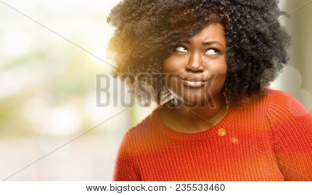 Beautiful african woman making funny face fooling, outdoor