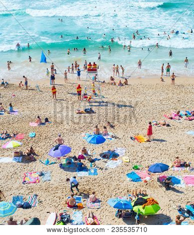 Nazare, Portugal - Aug 11, 2017: People At The Ocean Beach. Portugal Is A Famous Tourist Destination