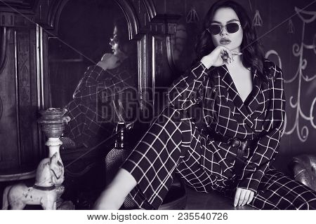 Beautiful Elegant Woman Dressed In A Blue Checkered Suit In Red Interior
