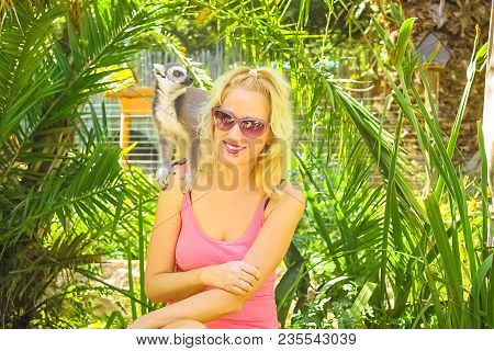African Wildlife Experience. Happy Woman Plays With Lemus Of Madagascar In Oudtshoorn, Western Cape,