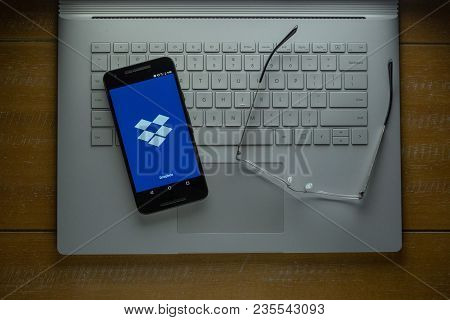 San Francisco, Ca - April 6, 2018: Dropbox App Loading On Android Phone In A Dark Room. The Company 