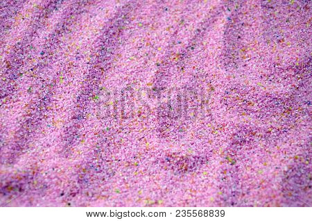 Texture Of A Colored Granular Sand Close Up. Pink Grains