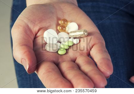 Multicolor Pills In Your Palm, Medications In Woman's Hand