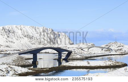 Famous Fredvang Bridges In Winter Sunny Day With Mountains Covered With Snow In Backgrond, Lofoten I