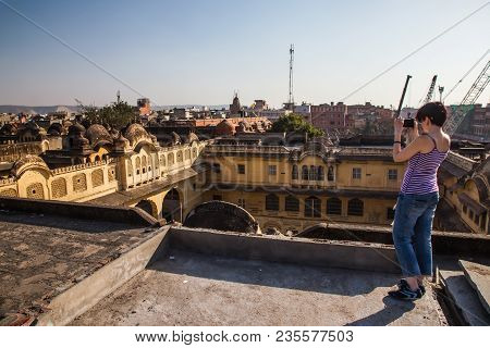 A Girl Takes Pictures Of The Old Part Of The City On A Smartphone. Old Eastern Buildings Jaipur. Ind