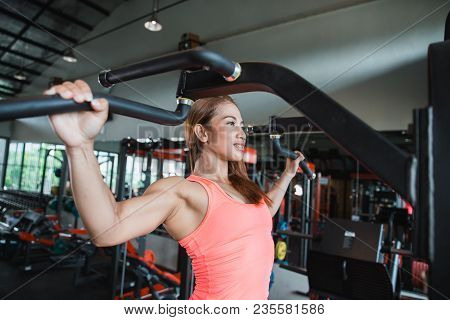 Close Up Young Adult Fitness Woman Doing Pull Ups In Pull Up Bar