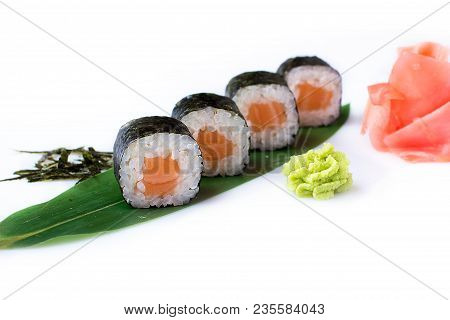 Delicious Fresh Mini-rolls With Salmon On A Banana Leaf. Sushi Rolls On A White Background With Ging