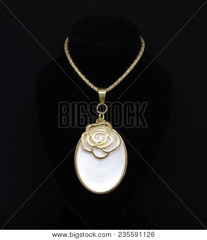 Gold Necklace With Bronze Rose Charm On White Gem Isolated On Black