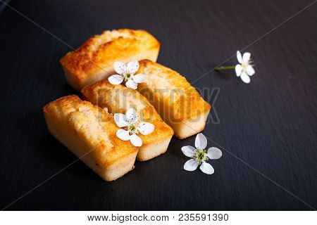 Food Concept Mini French Almond Cake Financier On Black Slate Stone With Copy Space