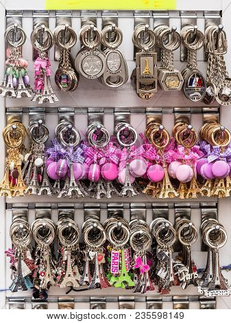 Paris, France - July 06, 2017: Various Colorful Souvenir Keychains With The Symbols Of Paris Are Lai