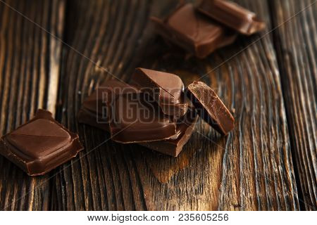 A Block From Delicious Dark Chocolate Bar Pieces On A Wooden Dark Old Table In Style Moodle