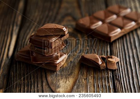 A Block From Delicious Dark Chocolate Bar Pieces On A Wooden Dark Old Table In Style Moodle