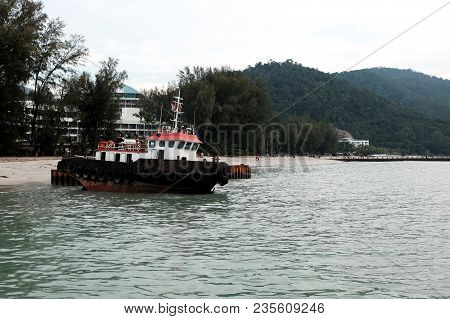 Black Tug Boat Achored Near The Sea Shore