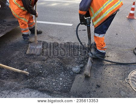 A Brigade Of Servants For Road Maintenance Removes The Old Asphalt With A Jackhammer And Shovels Int