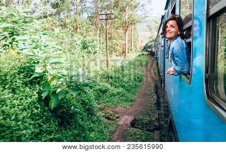 Happy Woman Looks Out From Train Window During Traveling On Most Picturesque Train Road In Sri Lanka