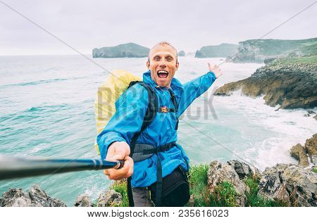 Smiling Backpakcer Traveler Take Selfie Photo On Ocean Coast