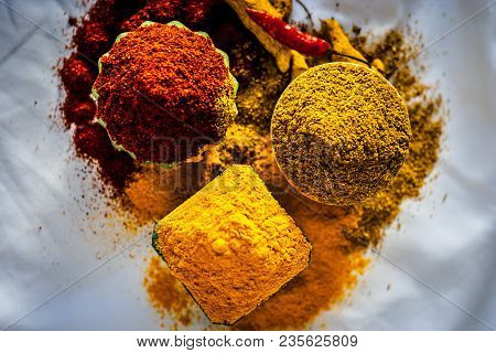 Close Up Of Three Basic Spices Of Indian Asian Food That Are Red Pepper Powder, Turmeric Powder And 