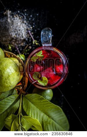 Close Up Of Popular Indian Shrabat Of Guava With Sugar And Masala In A Glass With Raw Fresh Guava On