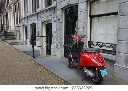 Amsterdam, Netherlands - July 10, 2017: Red Piaggio Vespa Scooter Parked In Amsterdam, Netherlands. 