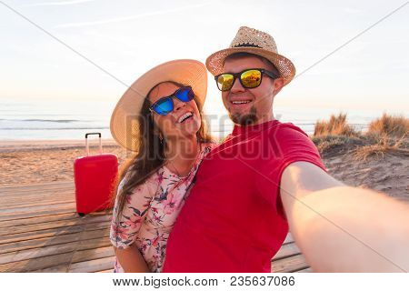 Happy Traveling Couple In Love Taking A Selfie On Phone With Suitcases At The Beach On A Sunny Summe