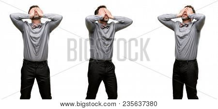 Middle age man, with beard and bow tie stressful keeping hands on head, tired and frustrated