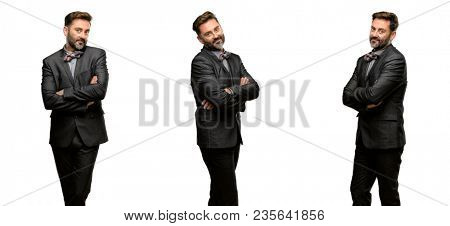 Middle age man, with beard and bow tie with crossed arms confident and happy with a big natural smile laughing