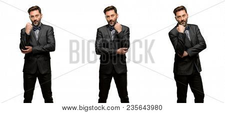 Middle age man, with beard and bow tie with crossed arms confident and serious