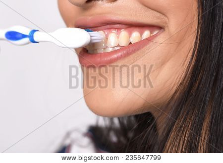 Close-up Woman Brushing Her Teeth. Isolated White Background.