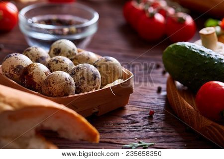 Fresh Eggs Of A Quail With Greens And Vegetables On Wooden Table, Selective Focus, Close-up, Shallow