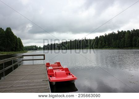 Beautiful Calm Lake Landscape With A Catamaran.