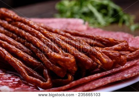 Thin Hot Sausages And Slicing Sausage On A Plate. Macro
