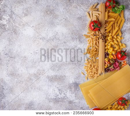 Various Type Of Pasta And Cherry Tomato. Top View
