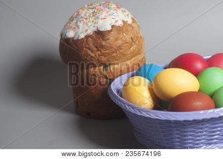 Easter Cakes And Colored Eggs On A Gray