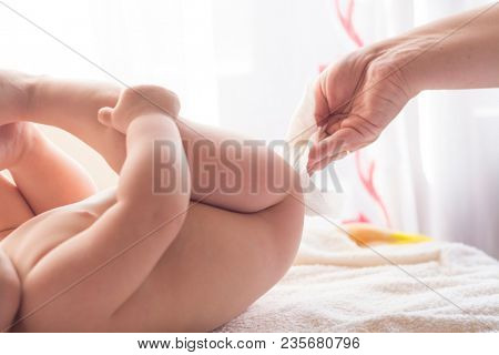 Hygiene - young momy wiping the baby skin with wet wipes. Cleaning wipe, pure, clean