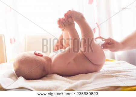 Hygiene - young momy wiping the baby skin with wet wipes. Cleaning wipe, pure, clean