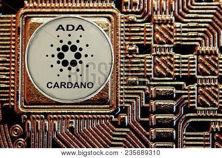 Coin Cryptocurrency Cardano On A Background Gold Circuit.