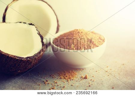 Coconut Palm Brown Sugar And Half Of Coconut Fruit On Grey Concrete Background. Copy Space.