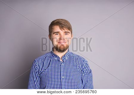 Portrait Of A Handsome Young Man Smiling Against Blue Background