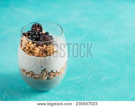 Triffle Dessert On Blue Tabletop With Copy Space. Blue Spirulina And Fruit Smoothie With Granola, Bl