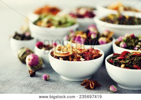 Assortment Of Dry Tea In White Bowls. Tea Types Backgound: Green, Black, Floral, Herbal, Mint, Melis