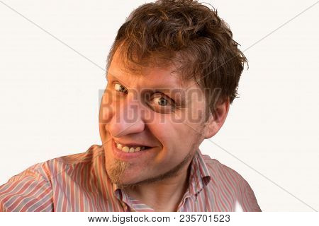 The Man Is Smiling Playfully In The Camera. Isolated Photo.