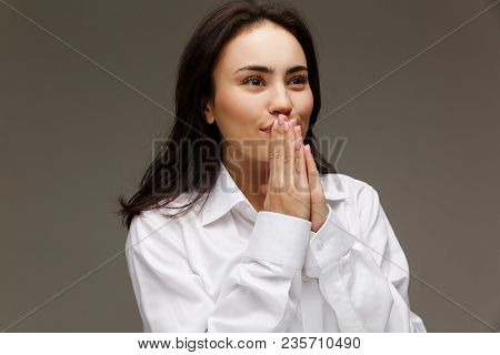 Beautiful Girl In A White Shirt Shows Emotions. On A Light Background.