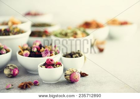 Assortment Of Dry Tea In White Bowls. Tea Types Backgound: Green, Black, Floral, Herbal, Mint, Melis