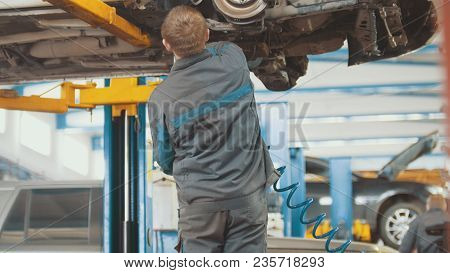 Automobile Service - Mechanic Wrapping Working Device Under Car Bottom, Slider
